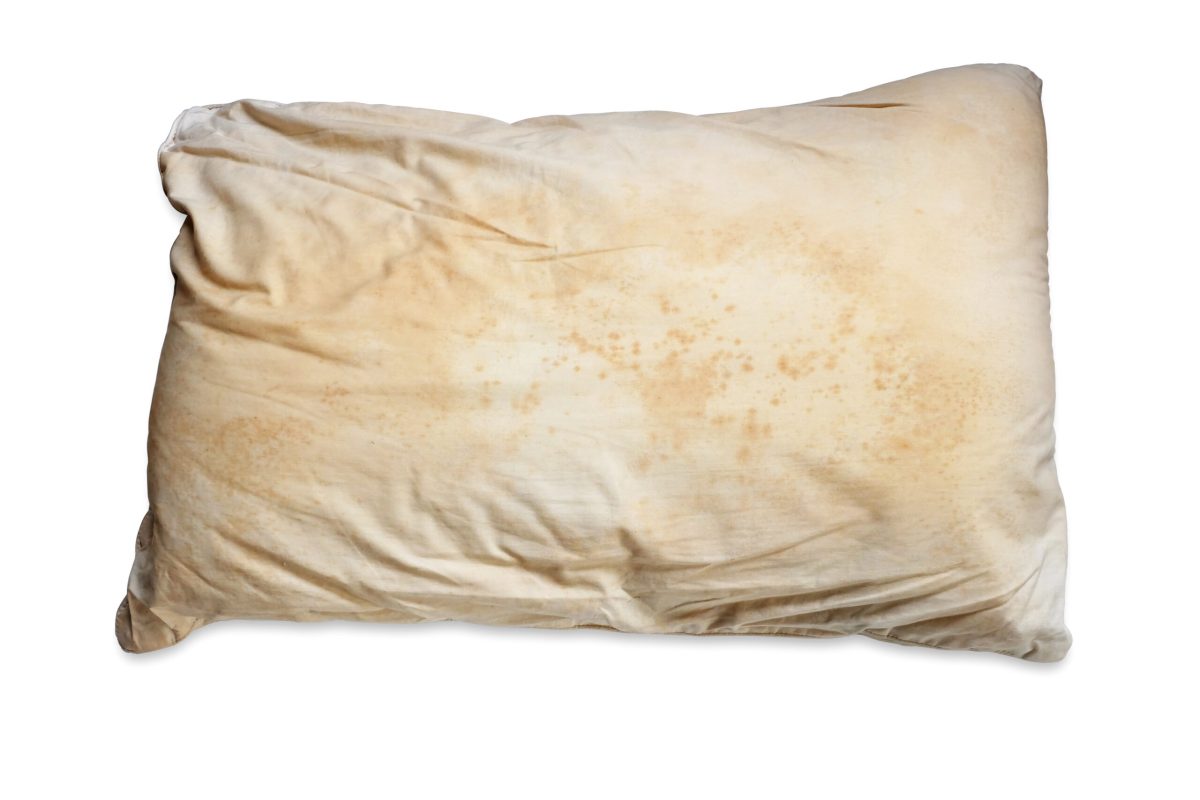 Dirty pillow isolated on white background, are a source of germs and dust mites and mattresses