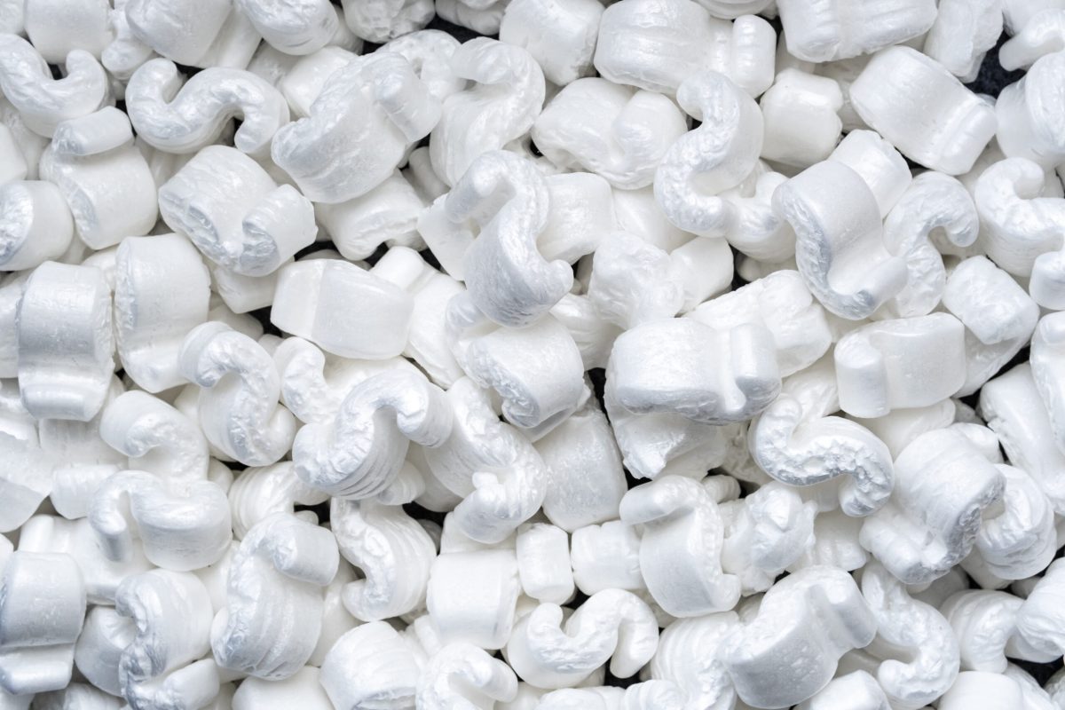 Photo of S-shaped packing peanuts used as a protective package in the delivery boxed. Background.